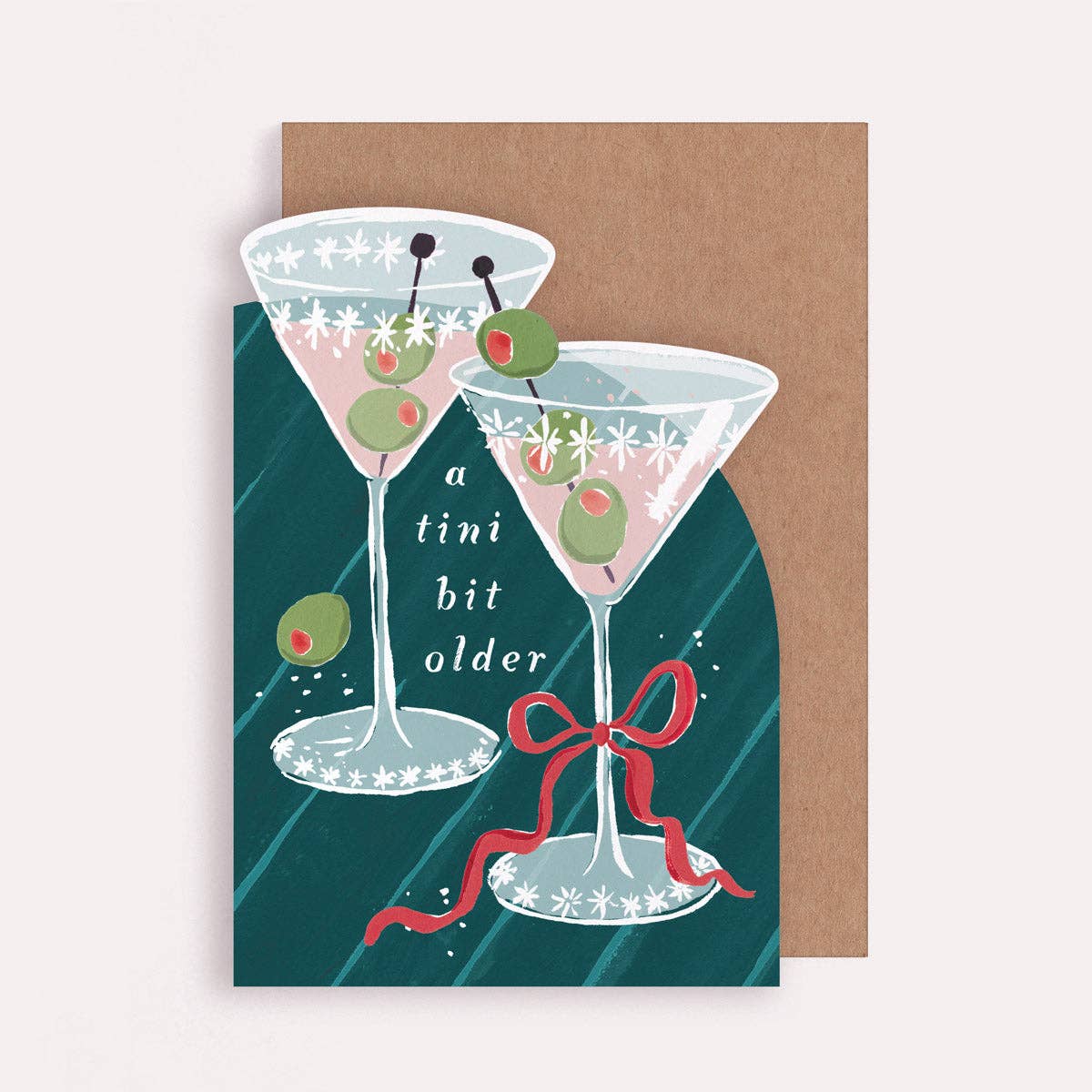 An illustrated birthday greetings card by Sister Paper Co in the shape of two martini glasses with text that reads "A Tini Bit Older".
