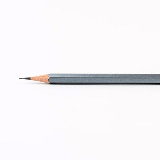 The iconic Blackwing 602 pencil with a gunmetal grey finish, sharpened to a fine point.