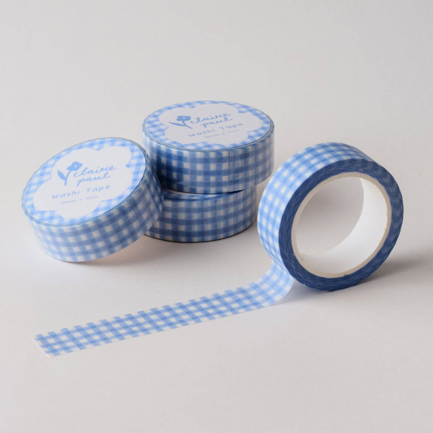 Stack of washi tapes featuring a cute pastel blue gingham. Designed by Claire Paul.