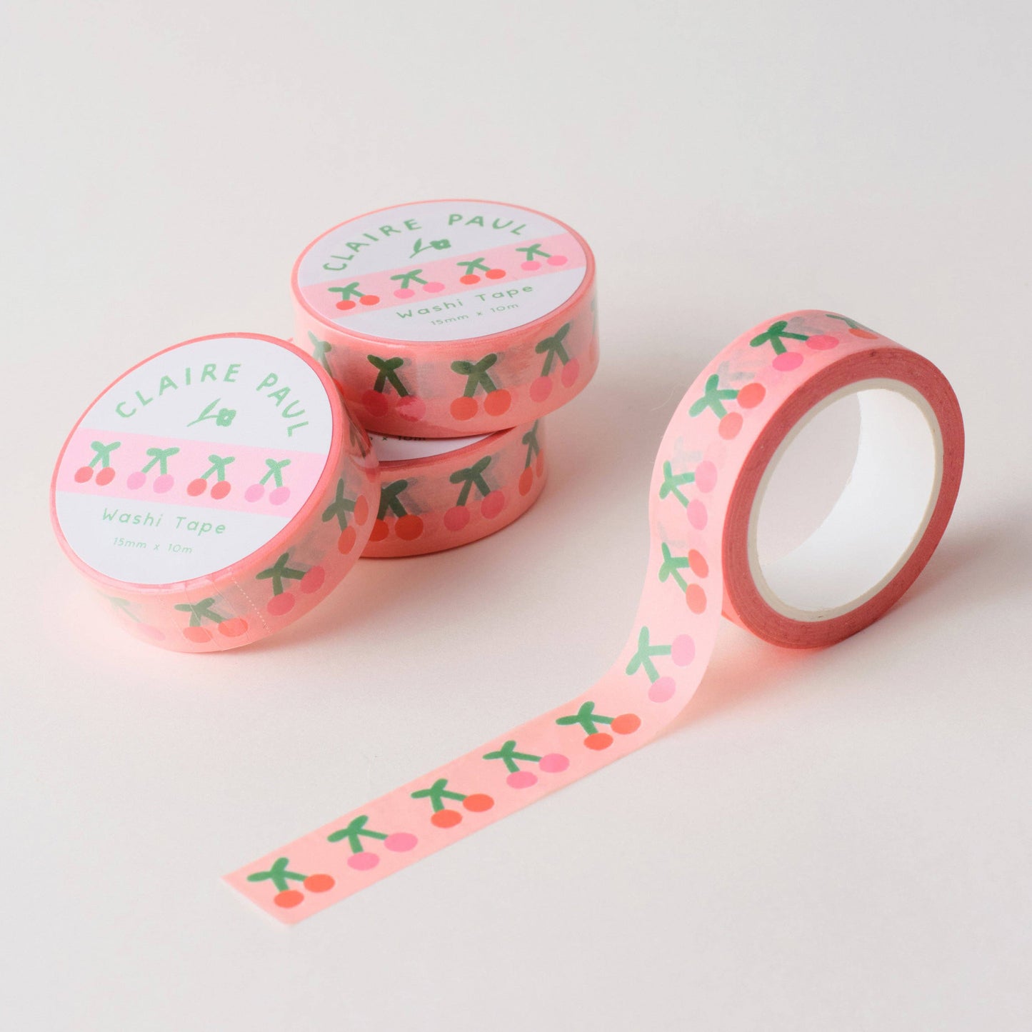 Stack of pink cherry patterned washi tapes featuring, designed by Claire Paul.
