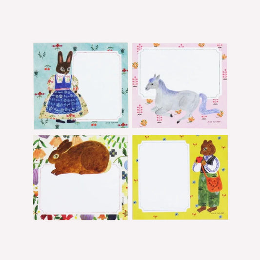 Cozyca Aiko Fukawa Flowers and Animals memo pad with four note designs of animal characters on pastel backgrounds with room to write notes.
