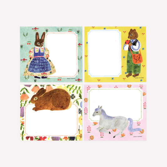 Cozyca Aiko Fukawa Flowers and Animals memo pad with four note designs of animal characters on pastel backgrounds with room to write notes.