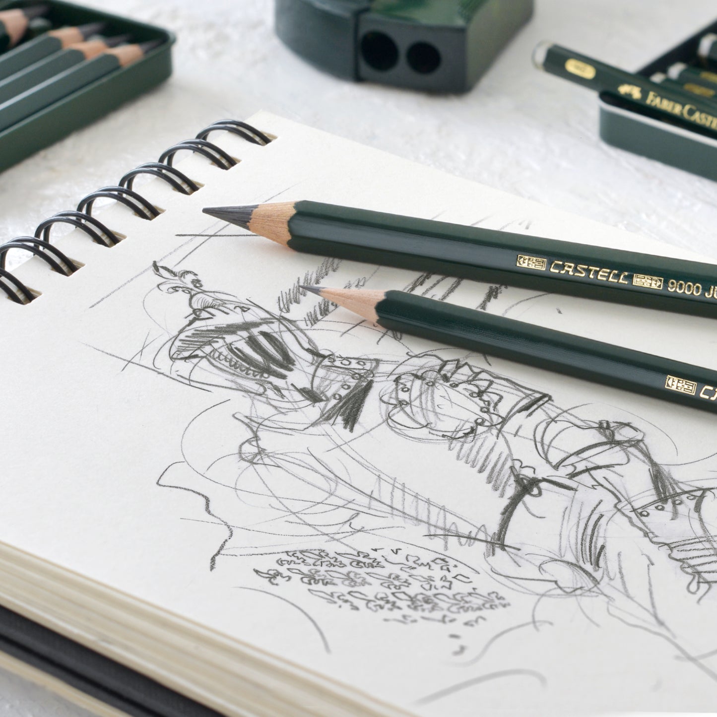 Faber-Castell 9000 graphite pencil lifestyle photography with pencils used to sketch a knight on a white sketchbook page.
