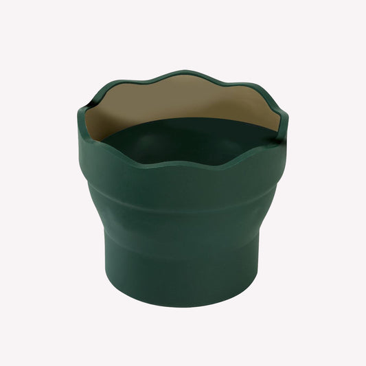 A 'Clic & Go' collapsable water pot by Faber-Castell, made from a flexible dark green rubber. The scalloped edge around the top is great for resting brushes when not in use.
