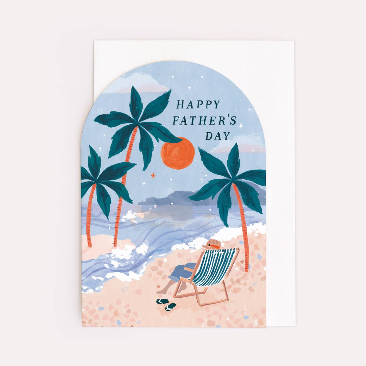 An arch shaped greetings card by Sister Paper Co with an illustration of a a man relaxing in a deckchair on the beach and text that reads "Happy Father's Day".