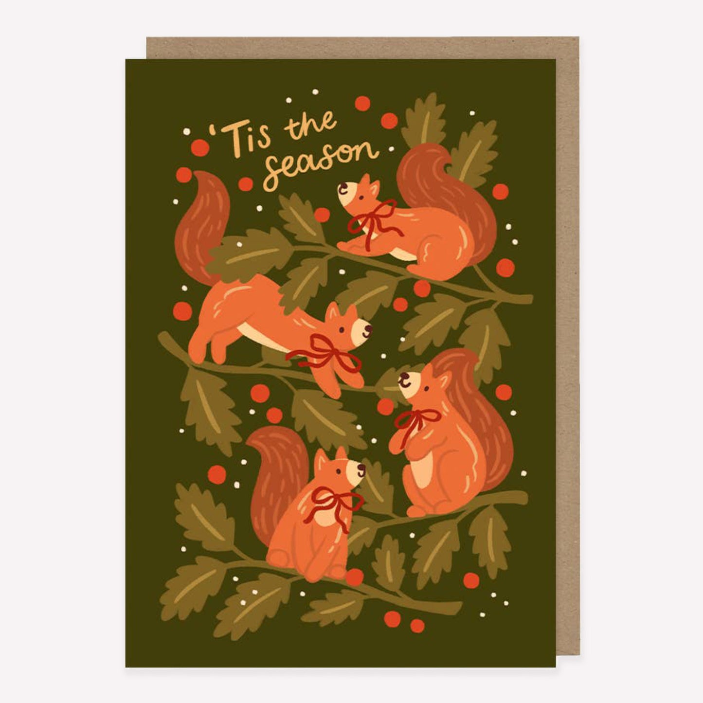 Illustrated Christmas greetings card featuring squirrels and winter foliage on a green background with handwritten text reading "Tis the Season".
