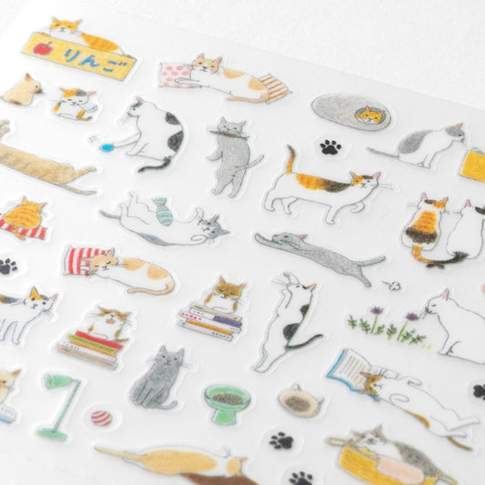 Close up look at the midori cat themed sticker sheet with hand drawn designs of cats playing and sleeping in muted grey, oramhe and beige colours.