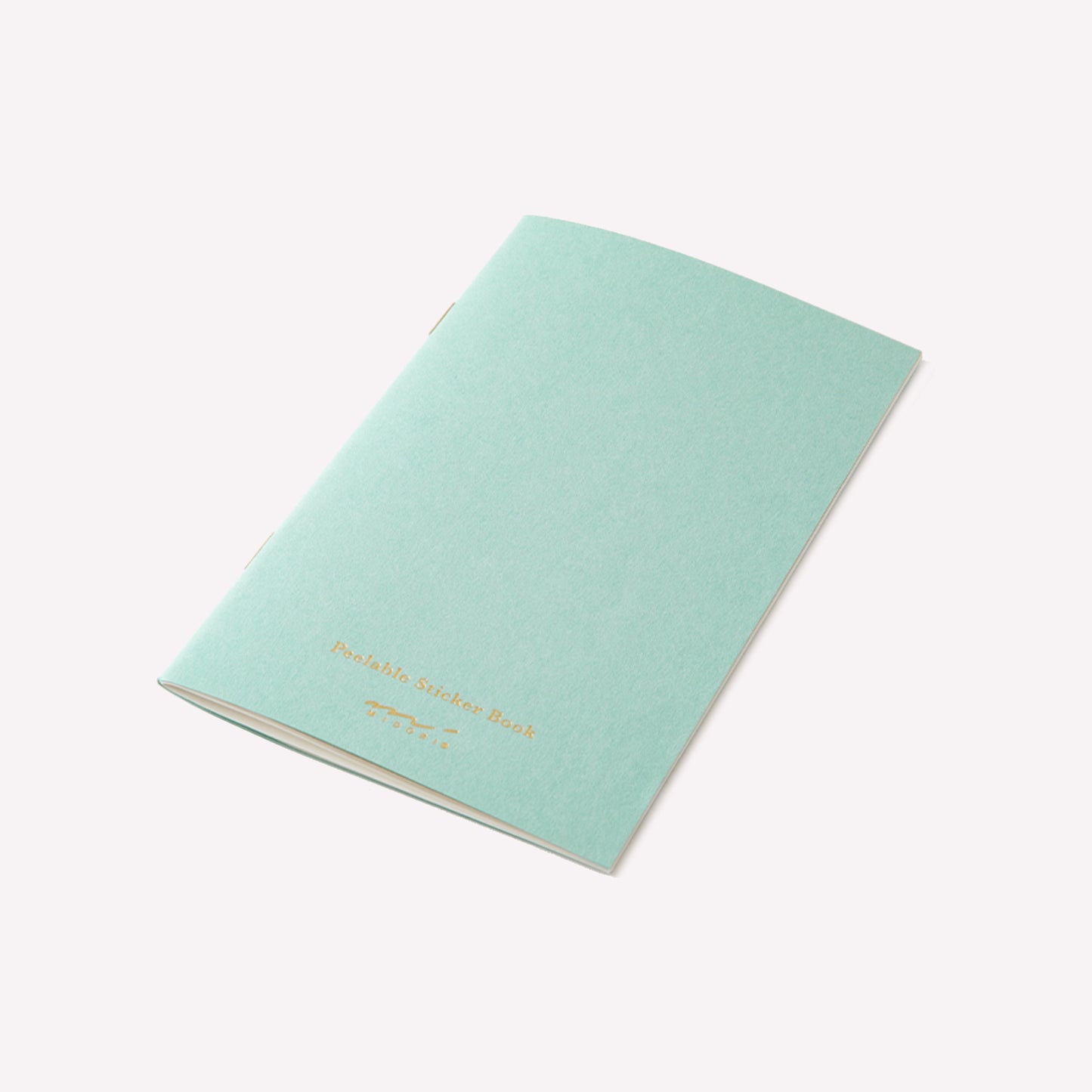 Midori peelable sticker book with a light blue cover and gold foil branding details.