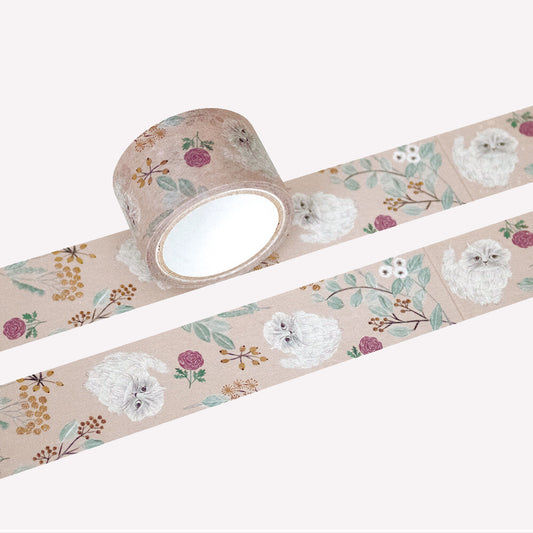 Miyuki Matsuo open roll and swatch of masking tape with floral and cat design on a on a peach background.