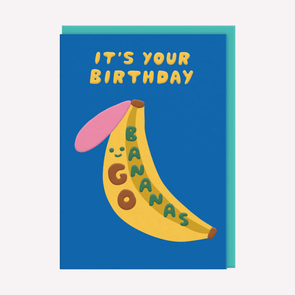 An illustrated kids birthday card by Suzy Ultman, printed by Ohh Deer. This card features an colourful illustration of a banana with text that reads “It's Your Birthday Go Bananas”.