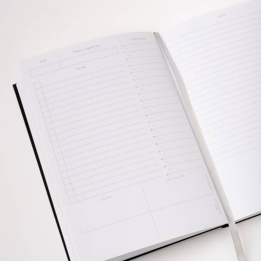 Close up of the internal pages of Ohh Deer's undated daily planner. The double page spread features room for the date, today's objective, to do lists, timetables and a lined page for notes.