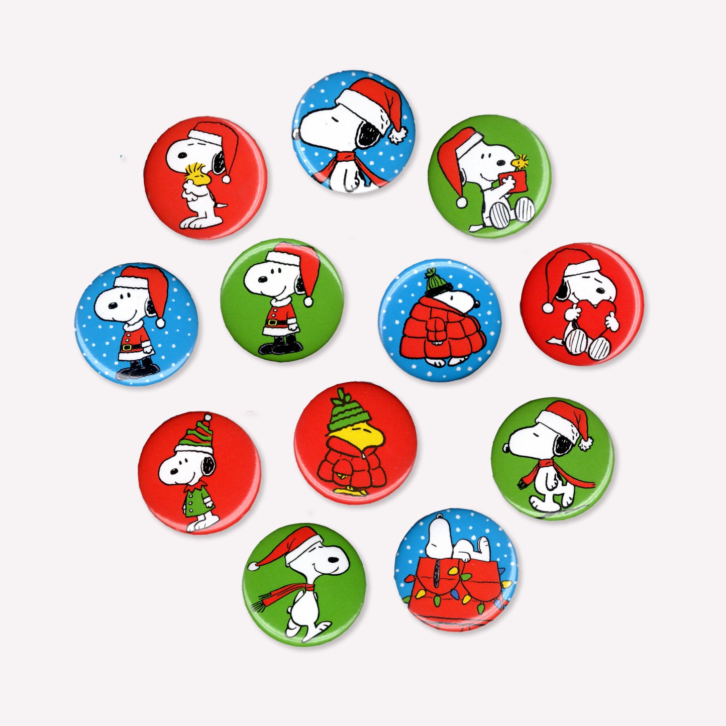 Twelve individual button badges featuring Snoopy and Woodstock in various festive outfits.