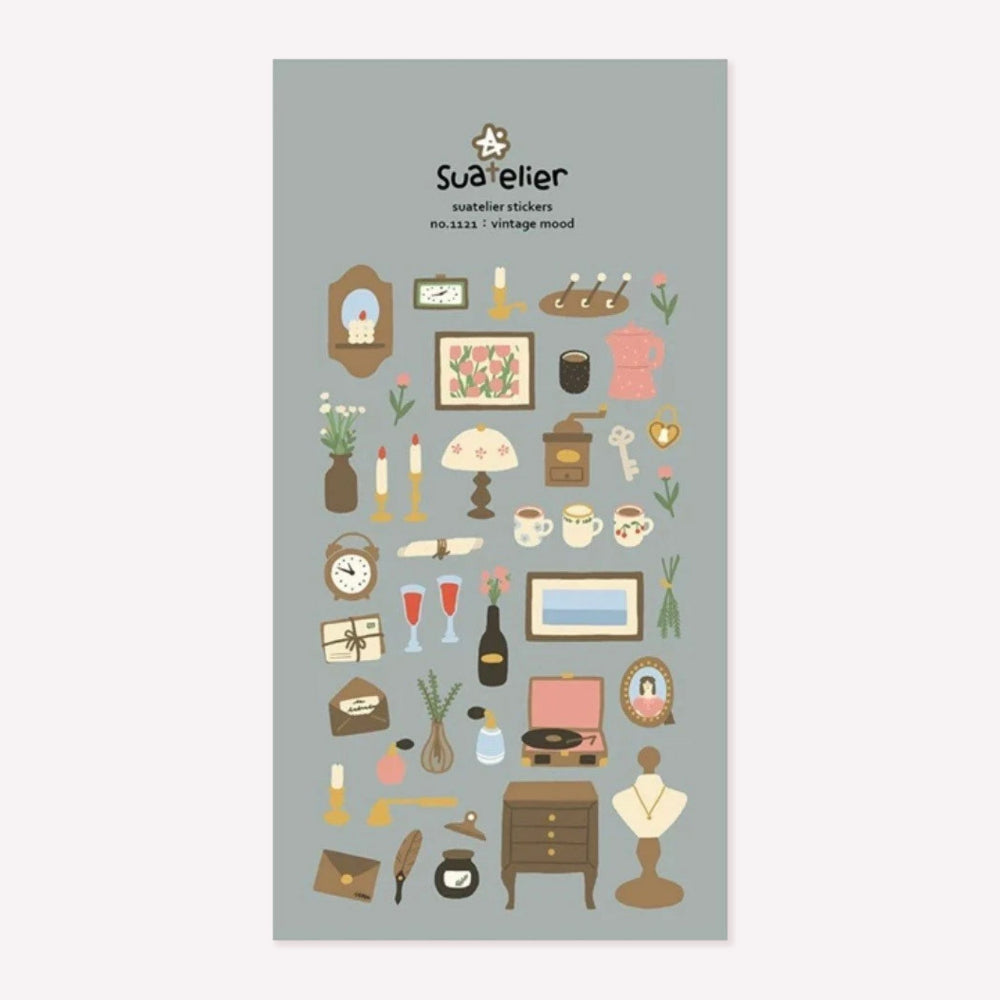 Illustrated sticker sheet no. 1121 "vintage mood" by Suatelier. This sticker sheet features a range vintage homeware stickers, including floral mugs, picture frames, candlesticks, letters, flowers and furniture pieces.