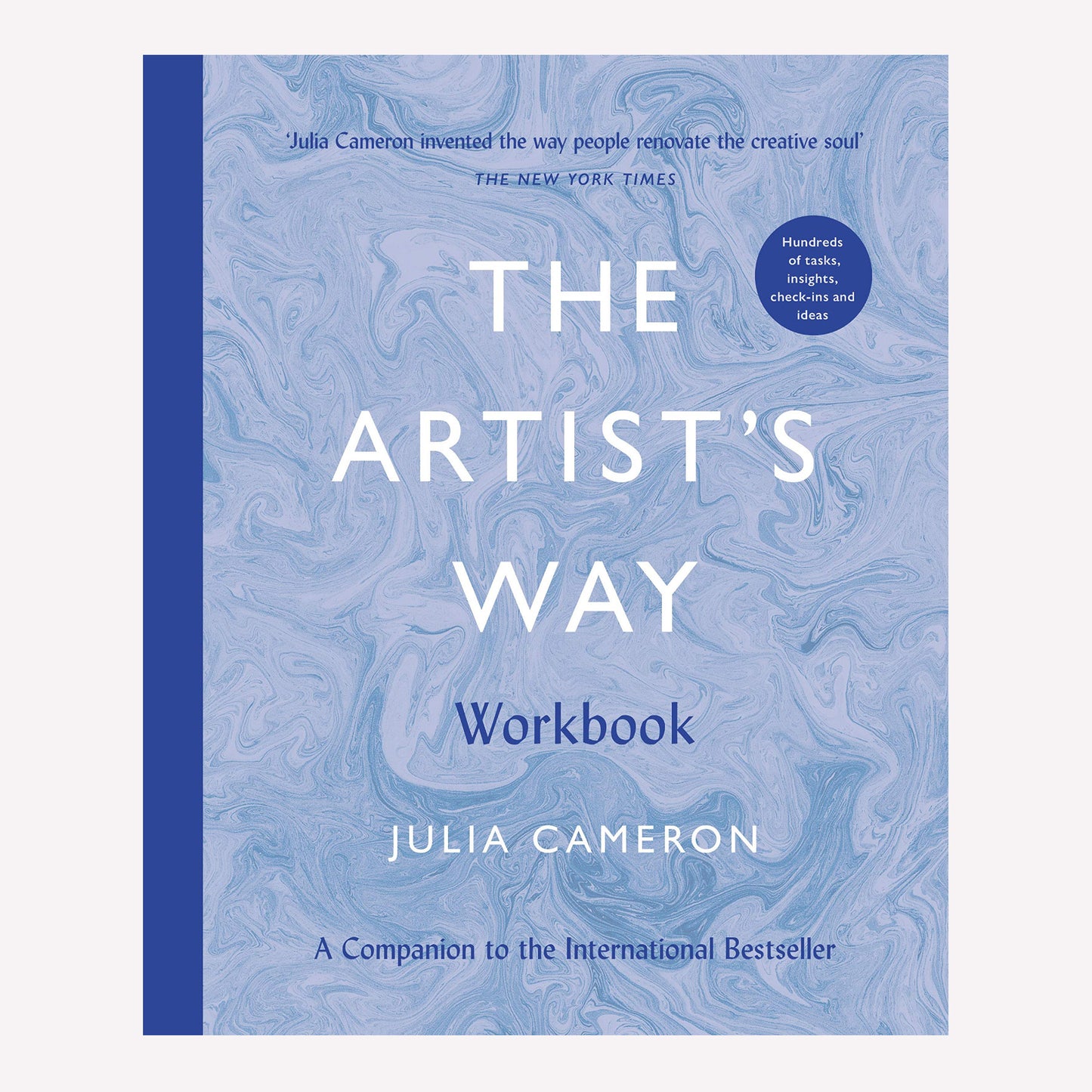 The Artist's Way workbook by Julia Cameron, with a blue marbled cover and royal blue spine. This book offers a structured course for those looking to reignite their creative spark.