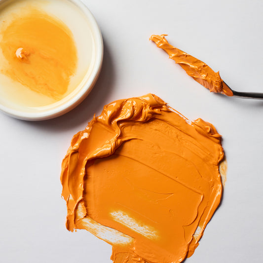 Orange paint colour swatch of Winsor & Newton's water mixable Safflower oil, used to extend the drying time and fatten paint colours.
