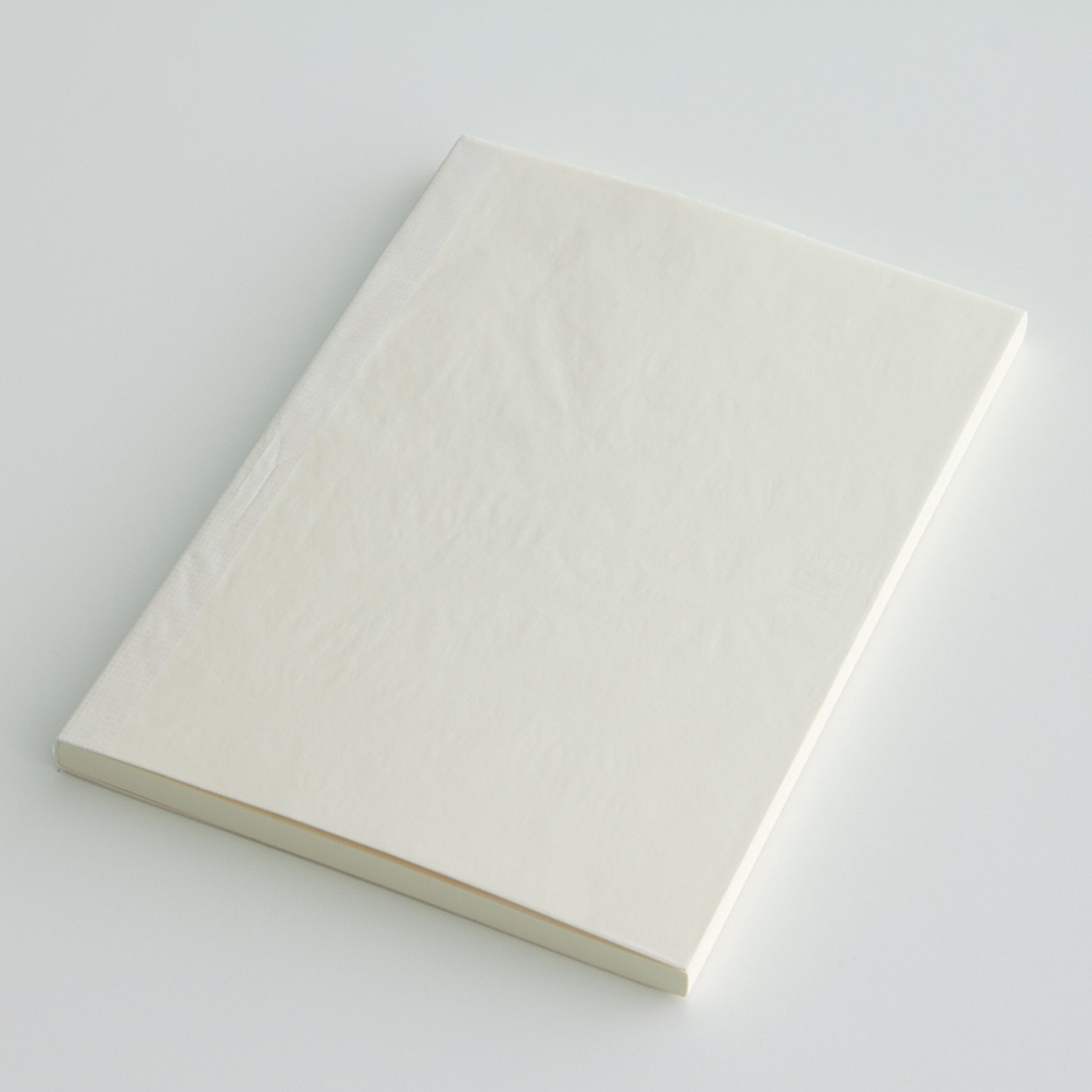 MD paper A7 blank notebook with a protective glassine cover. 