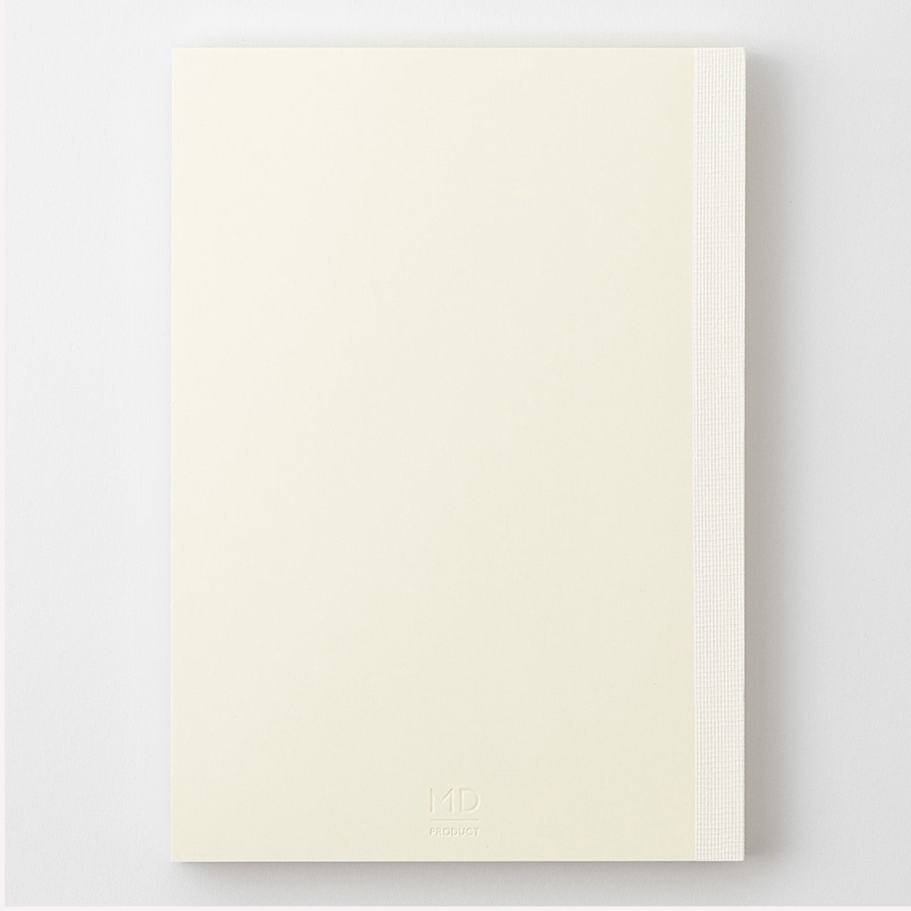 MD Product A5 notebook with a minimal cream cover, thread binding and the MD logo embossed on the back. 