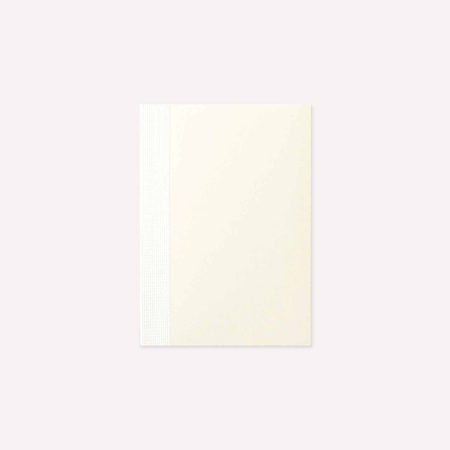 MD Product A7 Notebook with a minimalist cream cover and exposed stitch binding. 