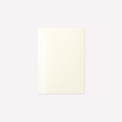 MD Product A7 Notebook with a minimalist cream cover and exposed stitch binding. 