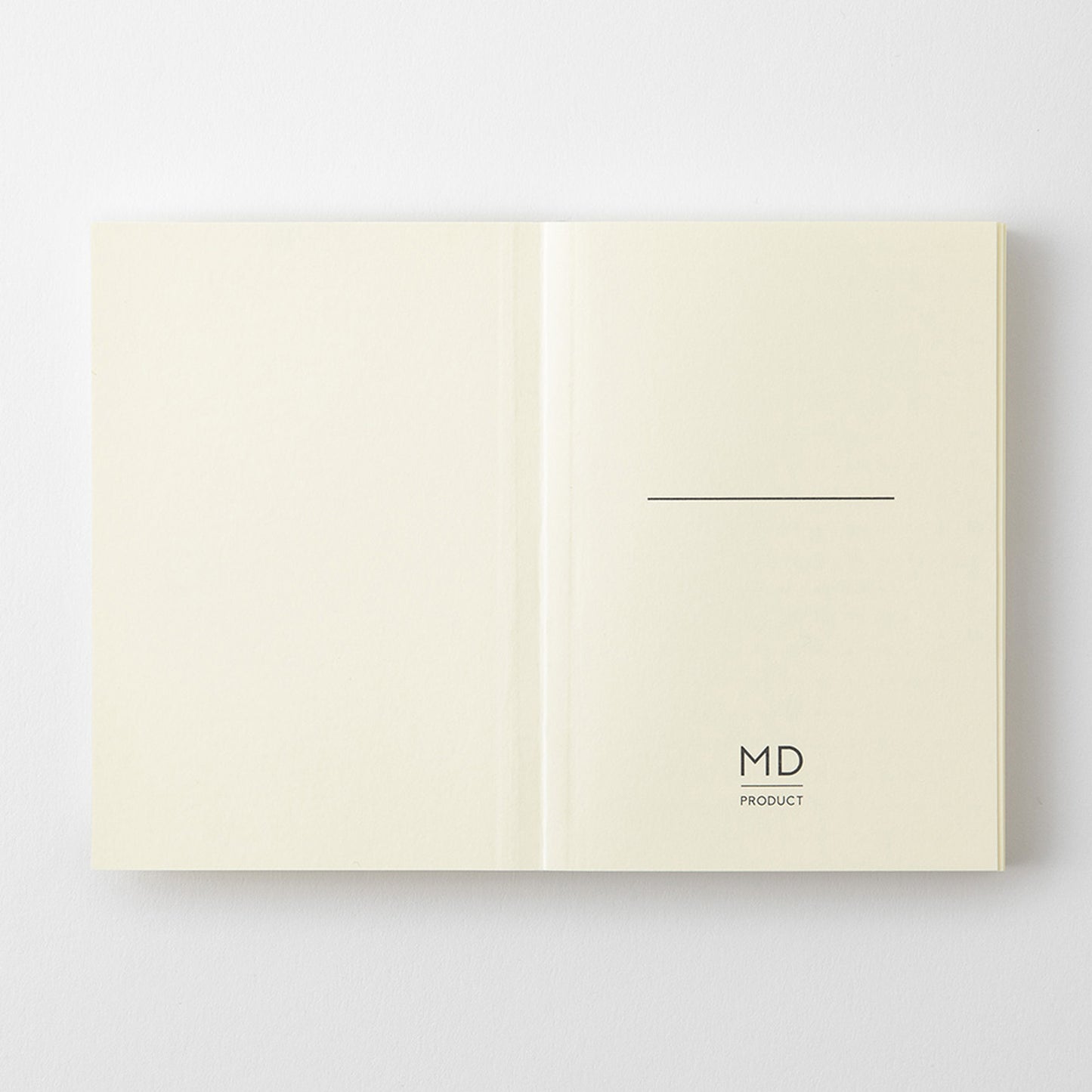 MD Product A7 notebook open on the first page with a minimalist design including space to write your name and the logo. 