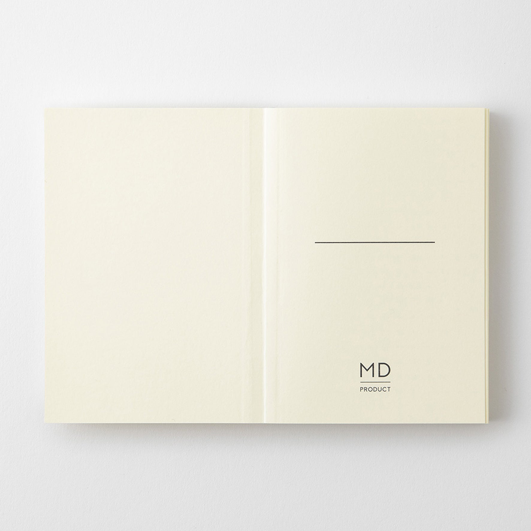 MD Product A7 notebook open on the first page with a minimalist design including space to write your name and the logo. 