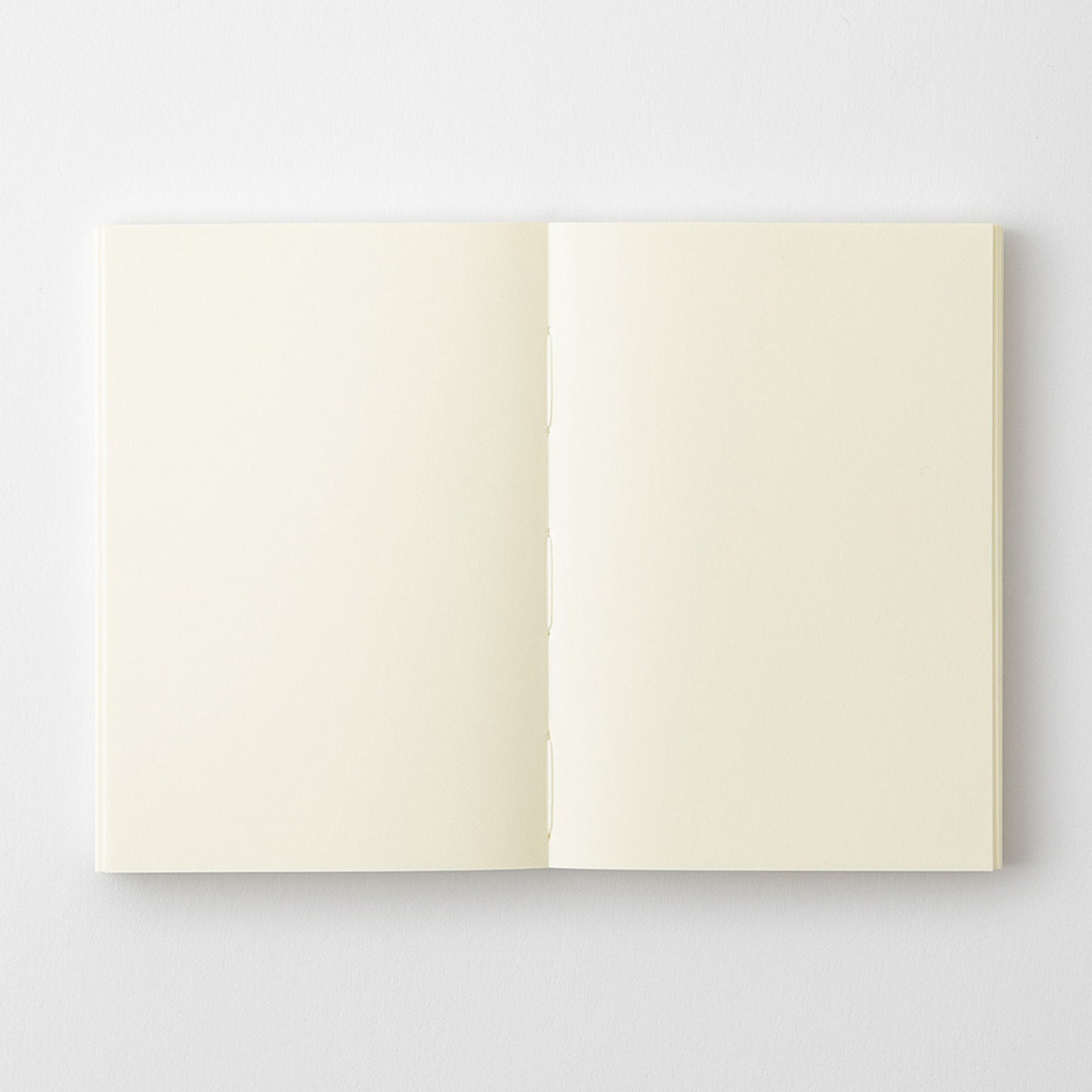 MD Product A7 notebook with open blank pages and stitch thread binding. 