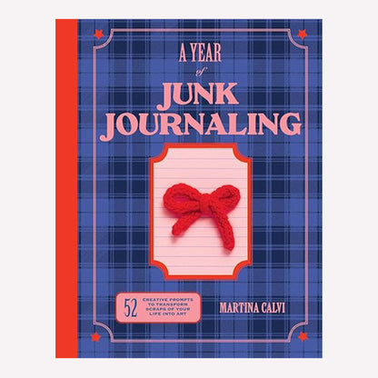 "A Year of Junk Journalling" Book by Martina Calvi with a blue tartan background, pink text, and red bow on the cover. 