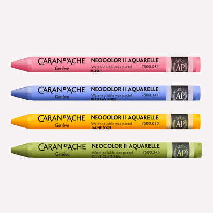 Four Caran d'Ache Neocolor II Aquarelle Wax Pastels in Pink, Periwinkle, Golden Yellow and Light Olive on a white background.
