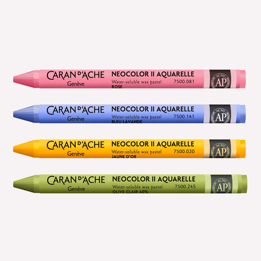 Four Caran d'Ache Neocolor II Aquarelle Wax Pastels in Pink, Periwinkle, Golden Yellow and Light Olive on a white background.