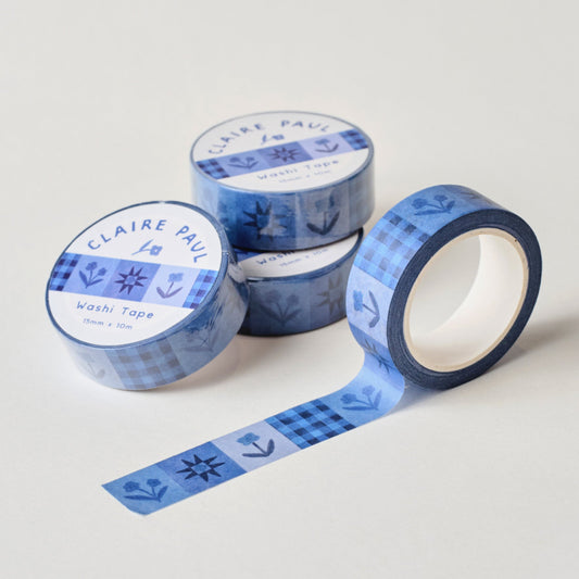 Several paper washi tapes by Claire Paul, all featuring a pattern of navy blue flowers and stars.