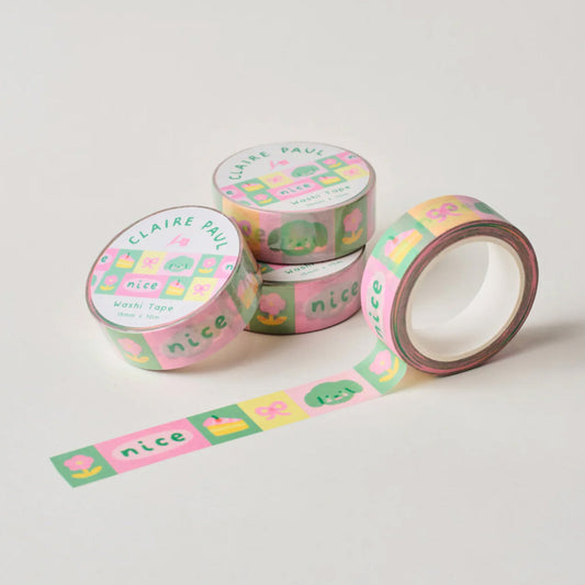 Several paper washi tapes by Claire Paul, all featuring a pattern of charms and trinkets in bright green, pink and yellow colours.