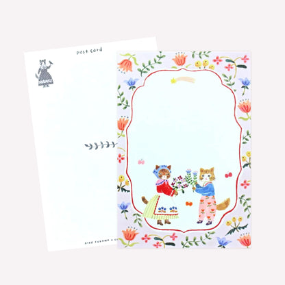Cozyca Aiko Fukawa postcard design featuring two cats dressed in cute outfits holding bouquets of flowers within a floral border. The revers features a postcard design with space to write a message. 