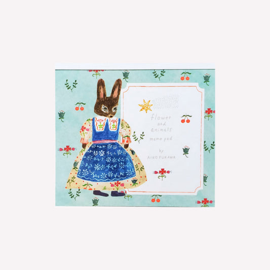 Cozyca Aiko Fukawa flower and amimals memo pad cover featuring a bunny character on a blue background with flowers and cherries. 