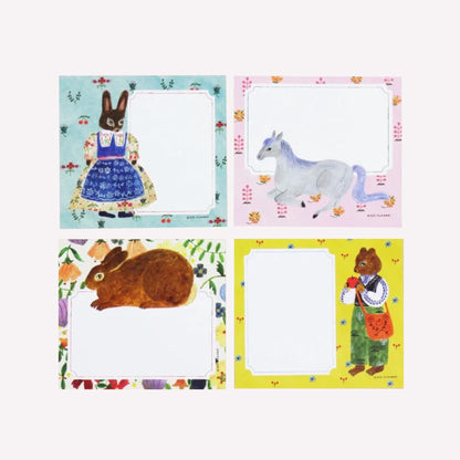 Cozyca Aiko Fukawa Flowers and Animals memo pad with four note designs of animal characters on pastel backgrounds with room to write notes. 