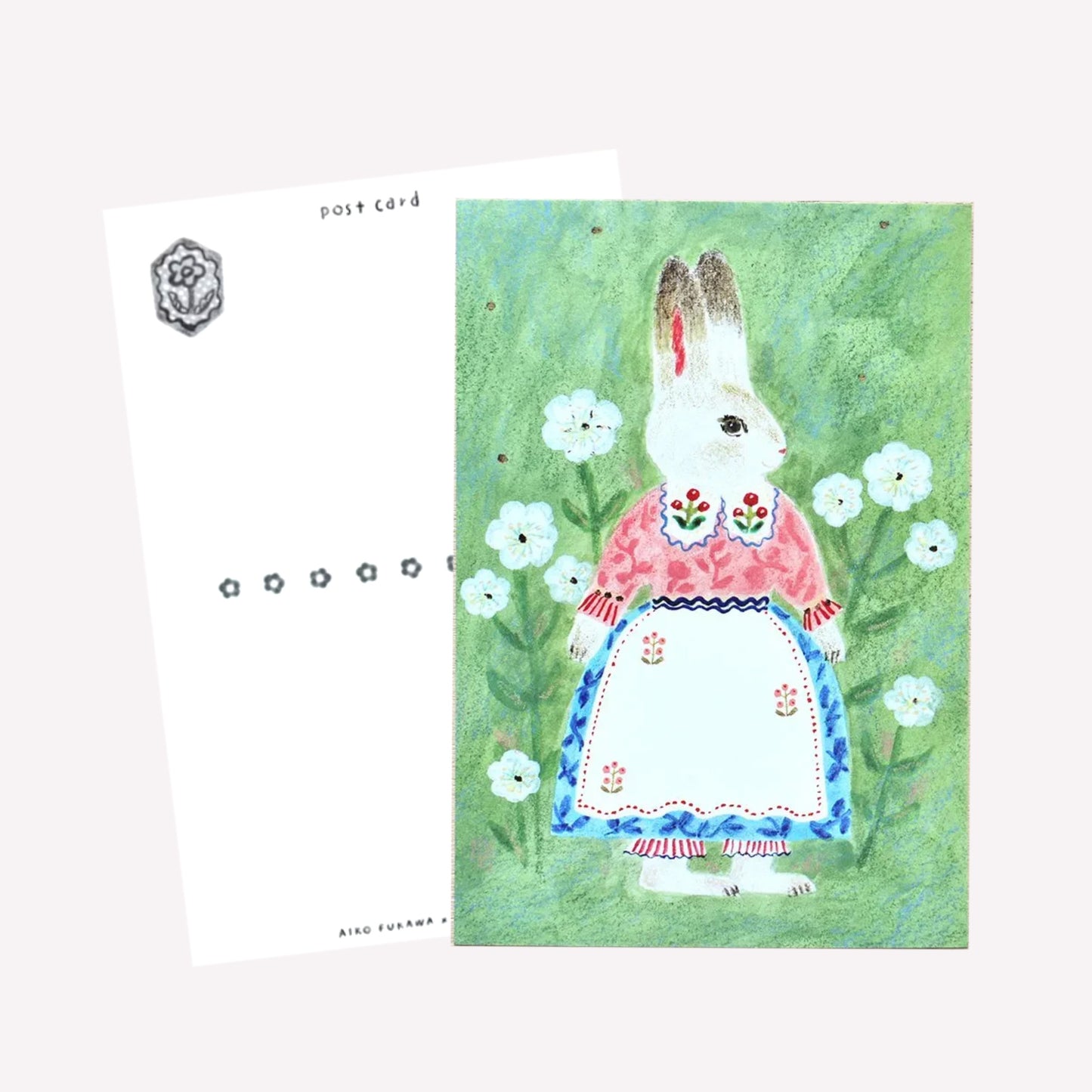 Cozyca Aiko Fukawa postcard design featuring a bunny character on a green meadow background. The reverse features a postcard design with space to write a message. 