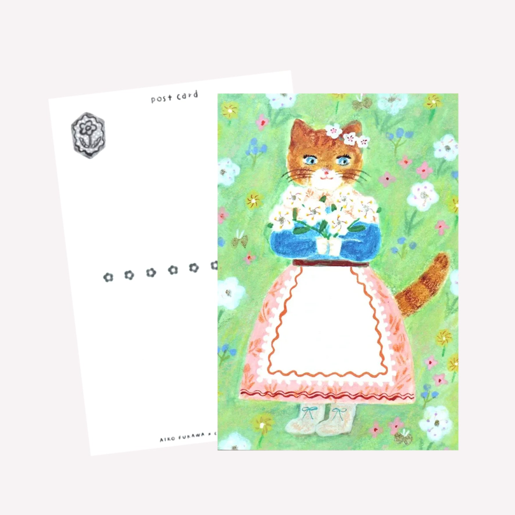 Cozyca Aiko Fukawa postcard design featuring a cat character dressed in a cute outfit holding bouquet on a green meadow background. The reverse features a postcard design with space to write a message. 