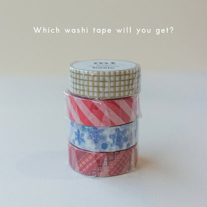 Stack of festive washi tapes by MT, including a gold grid, white and red stripe and blue snowflake design, all included in Salt Art Supply's festive stationery gift box.