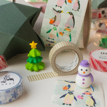 Items found inside Salt Art Supply's festive stationery star gift, including snowman and tree shaped erasers, festive patterned washi tapes and vintage penguin sticker sheets.