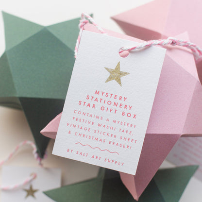 Close-up of the white gift tag for Salt Art Supply's mystery stationery star gift box, listing the contents.