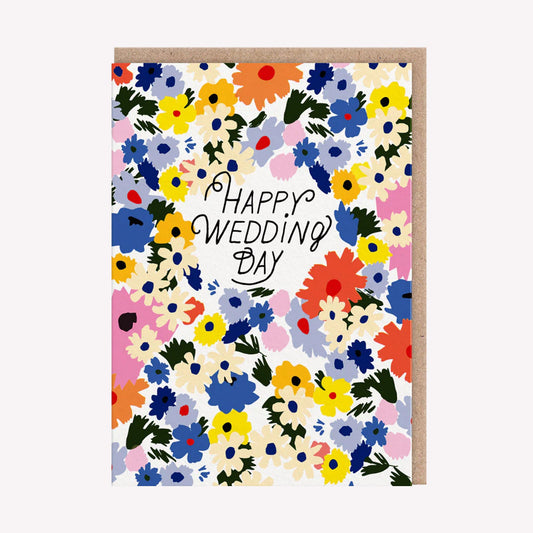 An illustrated greetings card by Hartland, printed by Ohh Deer. This card features bright and colourful floral design, with text that reads “Happy Wedding Day”.