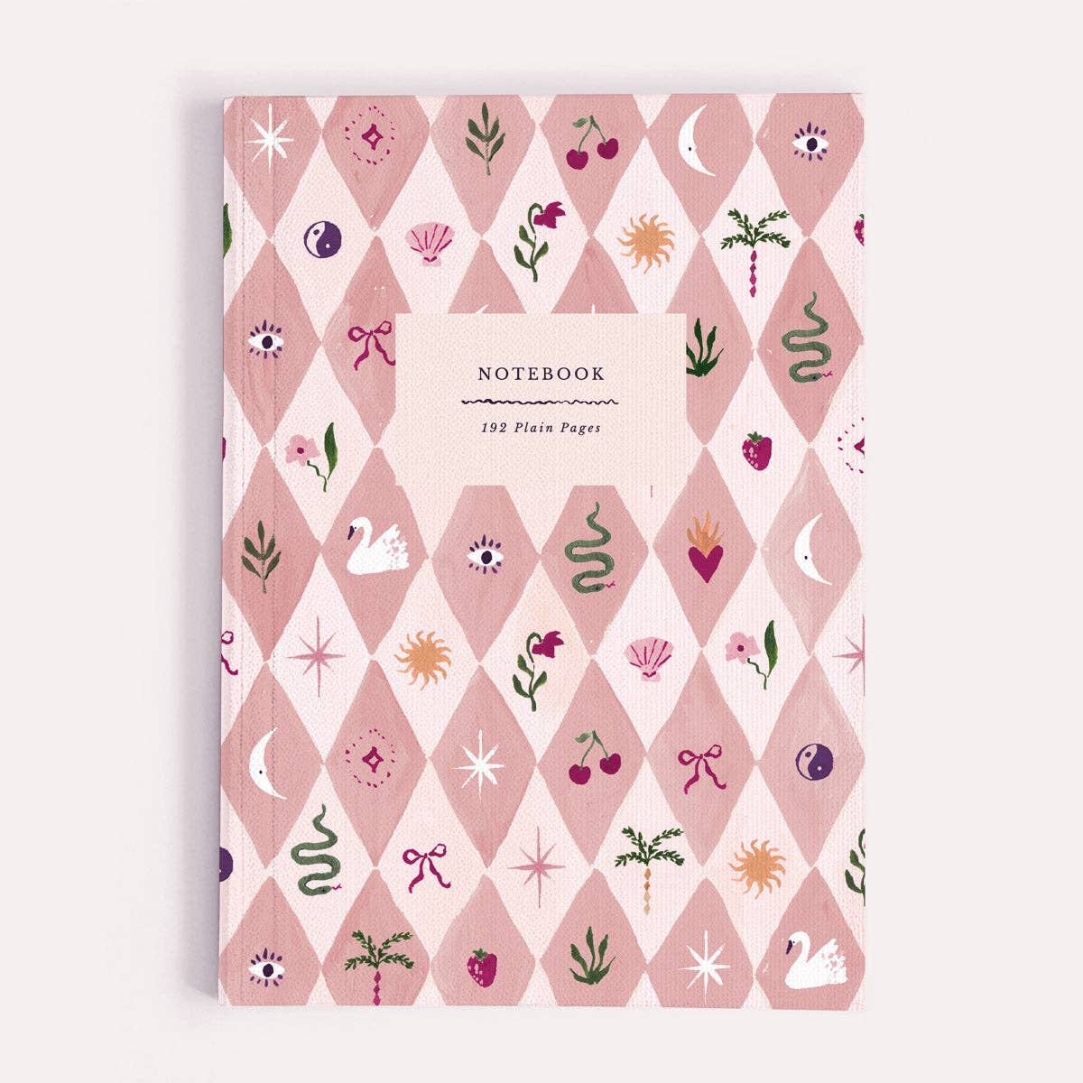 A plain paper notebook by Sister Paper Co, illustrated with a pink harlequin check pattern and tiny illustrated icons of trinkets and treasures. 