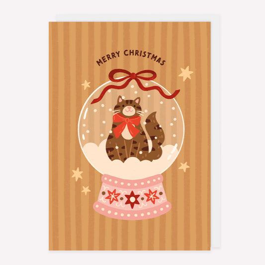 Illustrated Christmas greetings card featuring a cat in a snow globe with a ribbon and "Merry Christmas" text. 