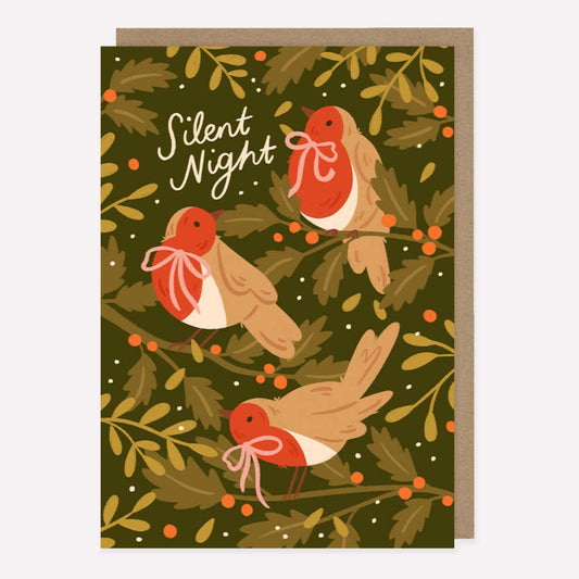 Illustrated Christmas greetings card featuring robins and winter foliage on a green background with handwritten text reading "Silent Night". 
