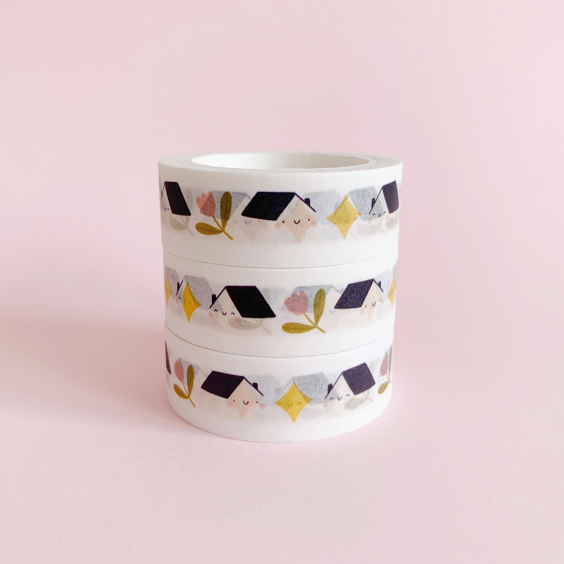 Set of three stacked paper washi tapes, featuring a repeating pattern of houses, tulip flowers and stars.