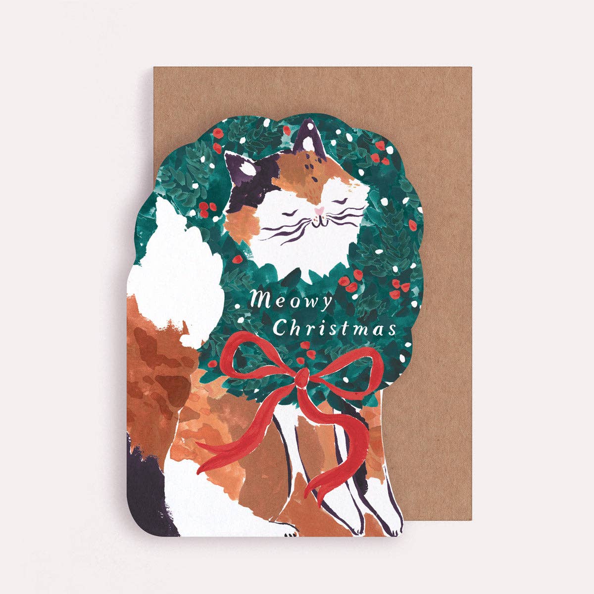 An illustrated Christmas card by Sister Paper Co in the shape of a cat with an oversized festive wreath rounds its neck, and text that reads "Meowy Christmas".