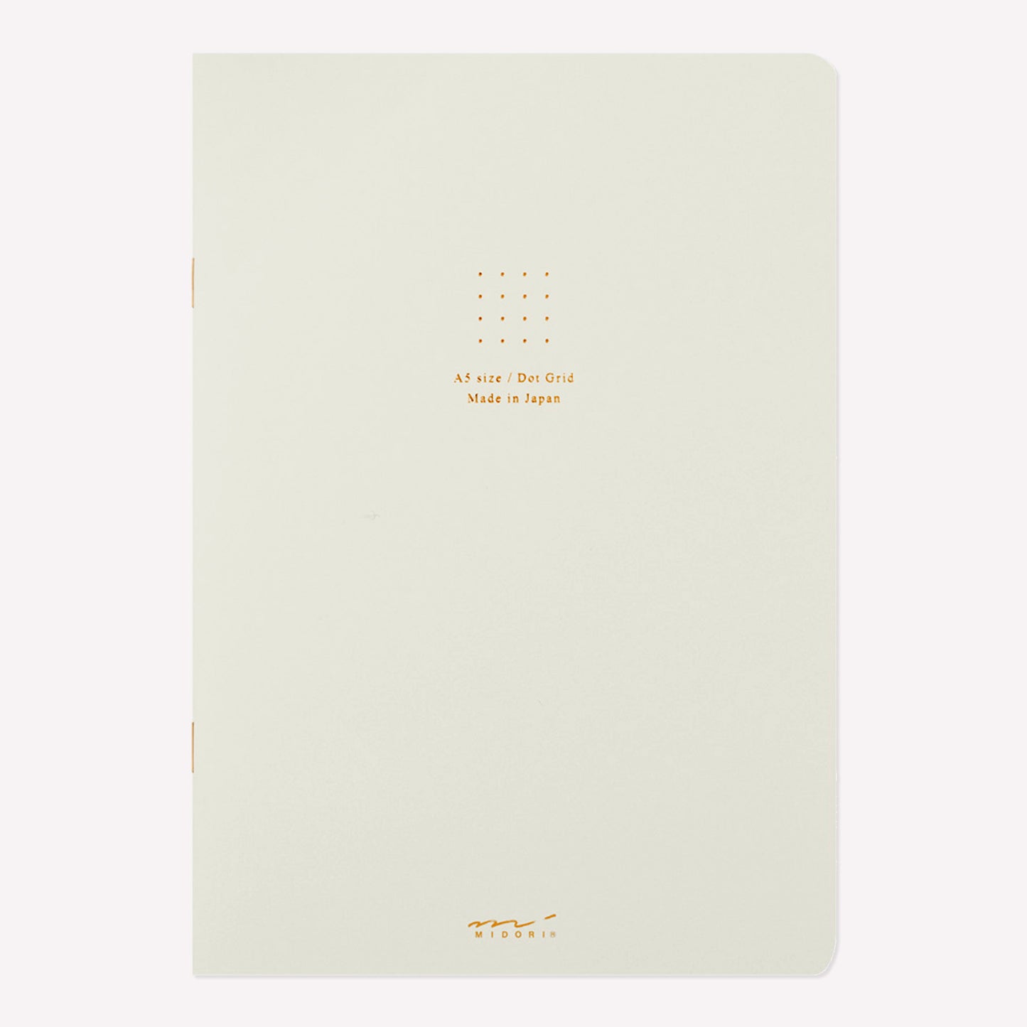 Front cover of the Midori white soft cover sketchbook with gold foil text in the centre reading "A5 size/Dot Grid. Made in Japan". 