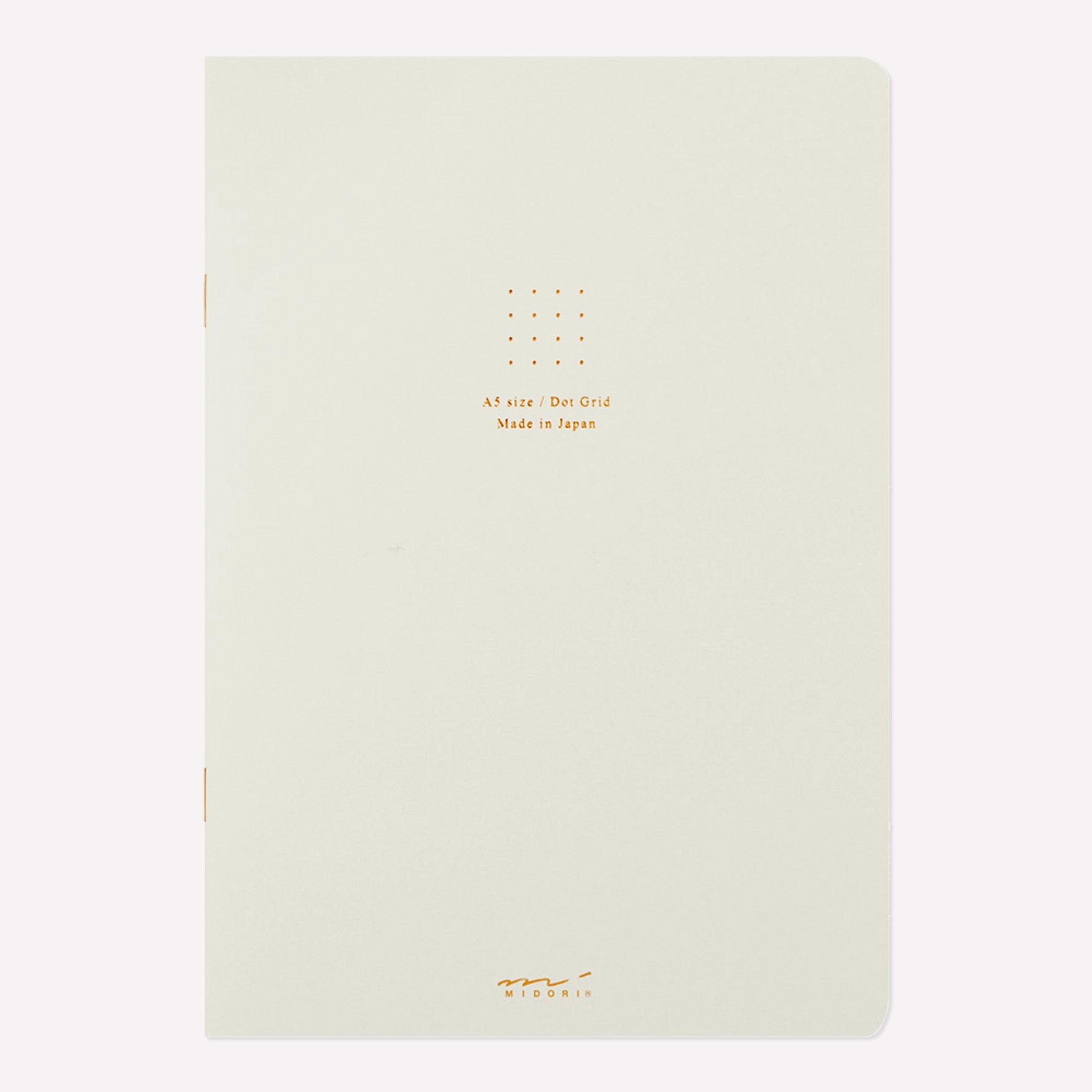 Front cover of the Midori white soft cover sketchbook with gold foil text in the centre reading "A5 size/Dot Grid. Made in Japan". 