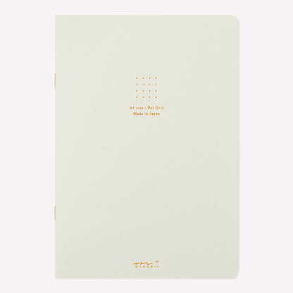 Front cover of the Midori white soft cover sketchbook with gold foil text in the centre reading "A5 size/Dot Grid. Made in Japan". 