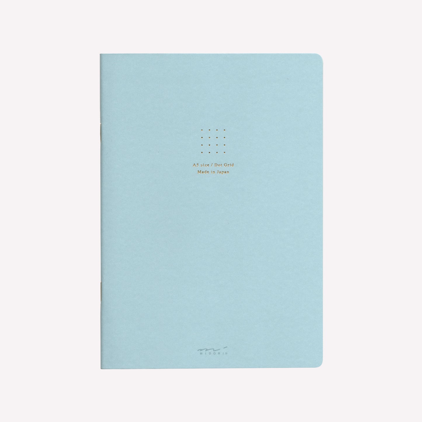 Front cover of the Midori blue soft cover sketchbook with gold foil text in the centre reading "A5 size/Dot Grid. Made in Japan". 