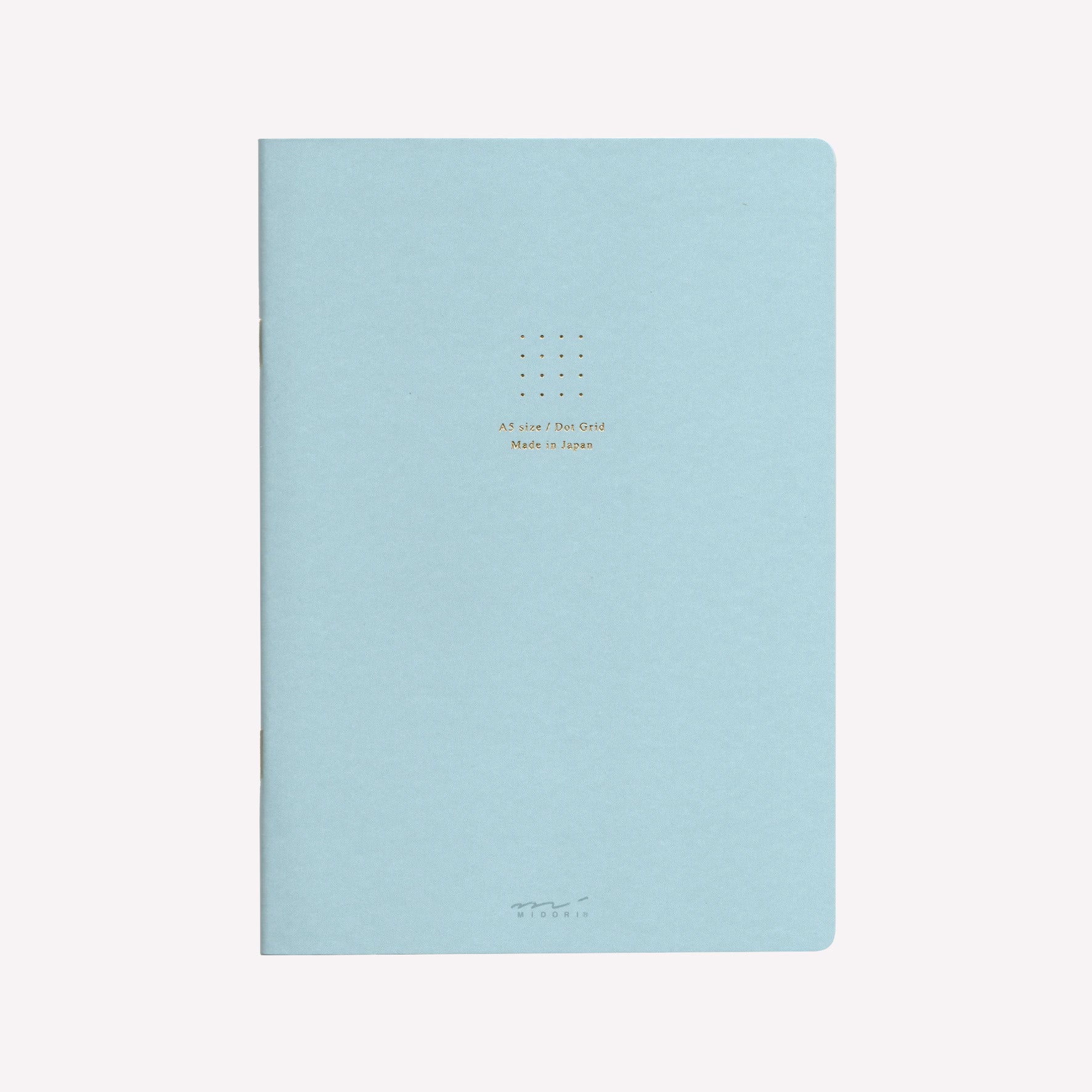 Front cover of the Midori blue soft cover sketchbook with gold foil text in the centre reading "A5 size/Dot Grid. Made in Japan". 